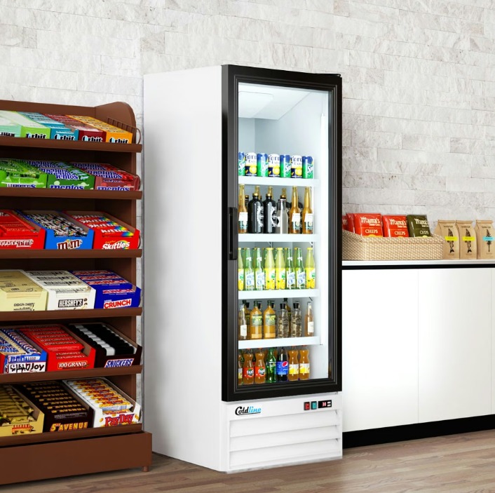 Single-door merchandiser refrigerator next to a shelf full of candy bars. A smaller counter with chips sits nearby.