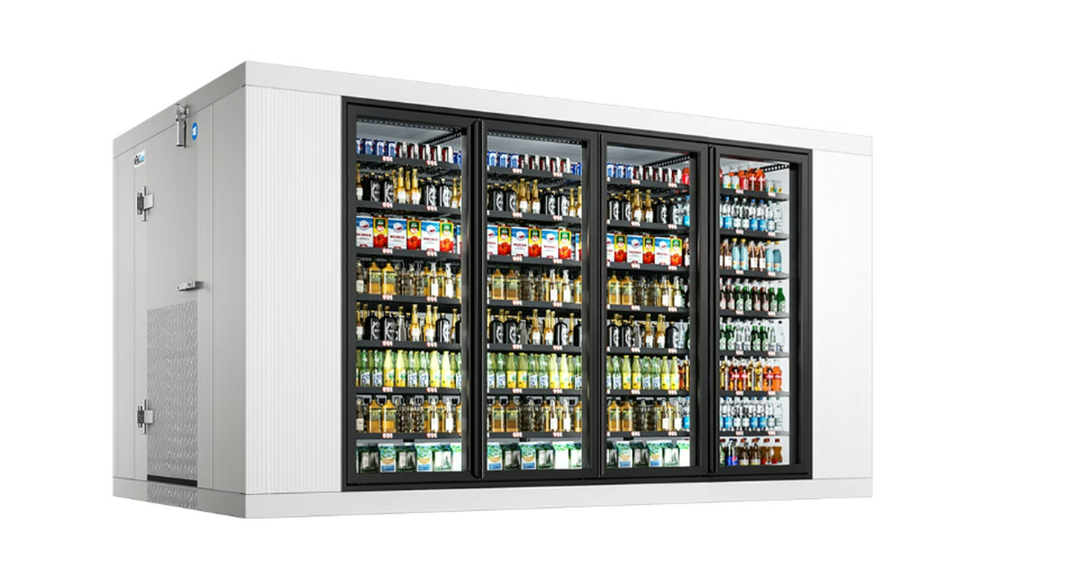 A massive metal commercial walk-in cooler with four rows of colorful drinks behind tall glass doors.